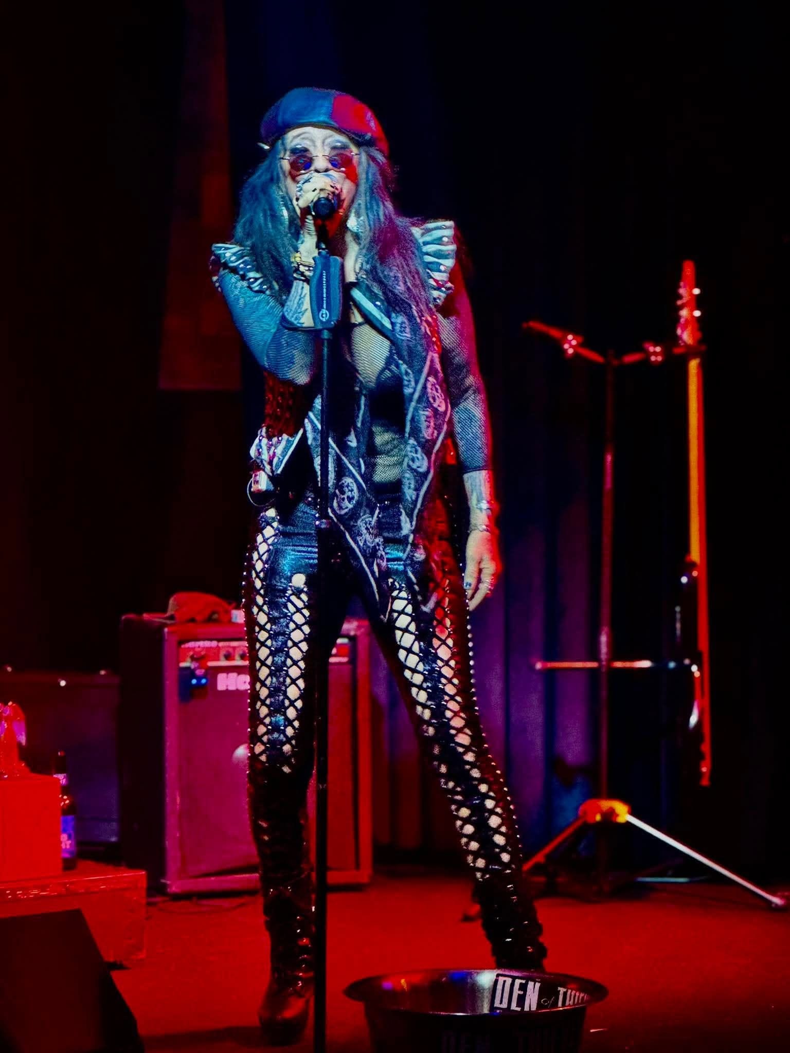 Angie Campbell on stage colorfully lit