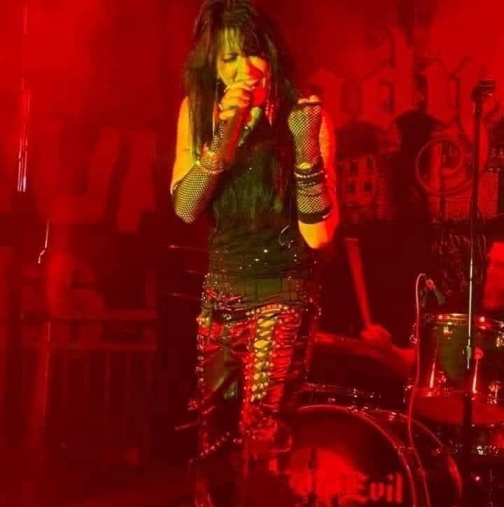 Angie Campbell performing under red stage lights