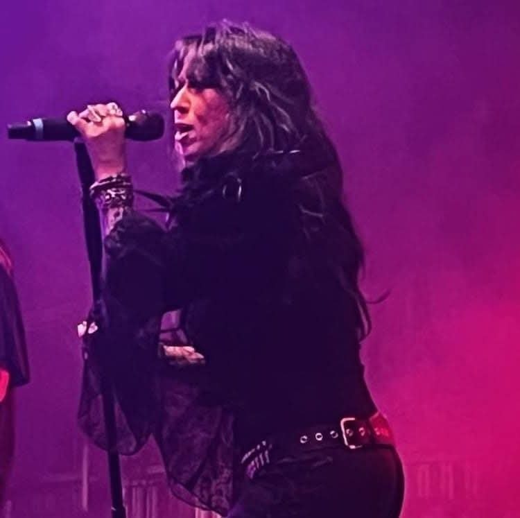 Angie Campbell singing under purple and pink lights